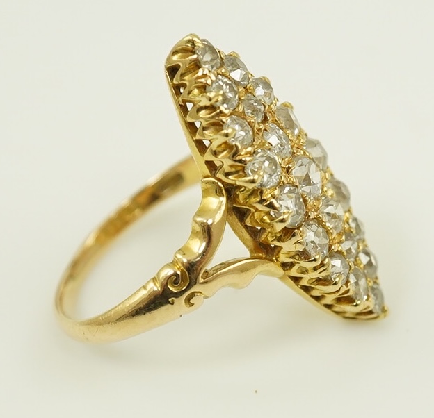 An early 20th century gold and diamond cluster set marquise shaped ring